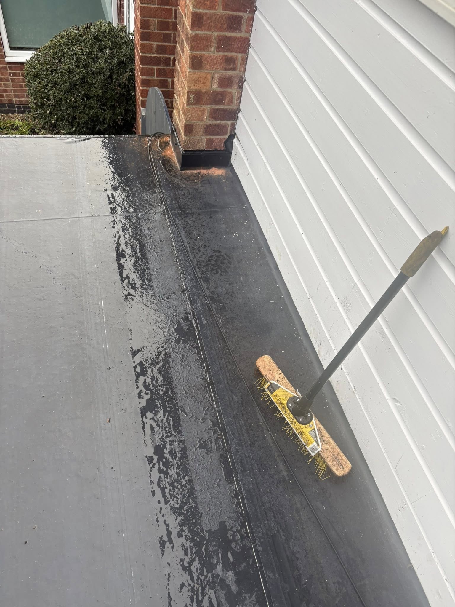 Brush on top of rubber roof